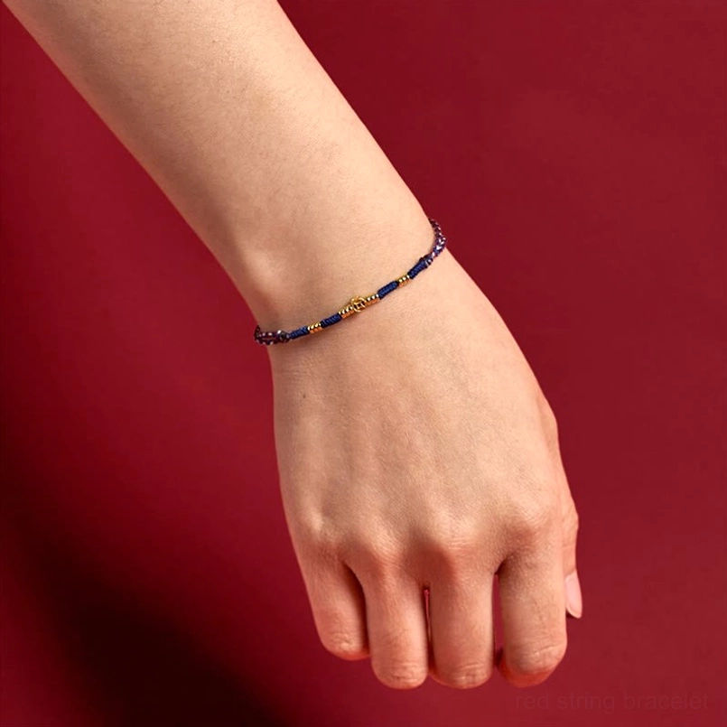 Complete red string bracelet collection showing multiple color variations and copper coin designs