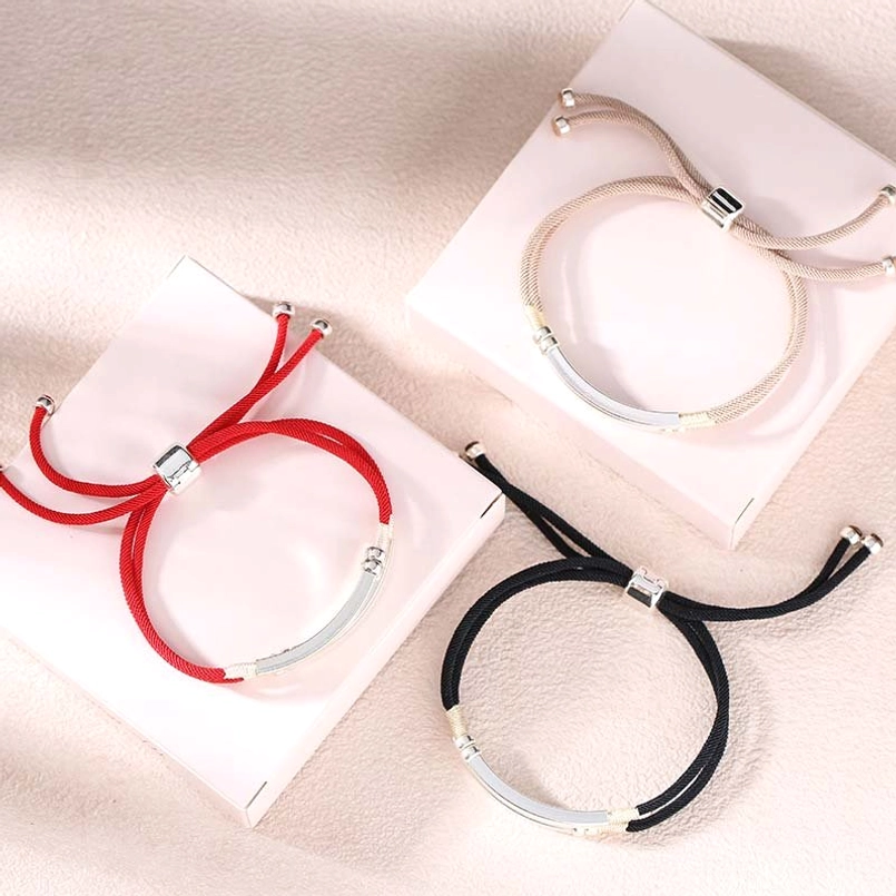 Multiple color variants of Sterling Silver Red String Bracelets displayed on pink jewelry gift boxes