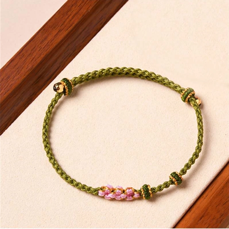 Dark green peach blossom red string bracelet with floral charms detail