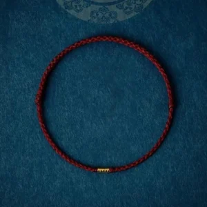 Dark red braided string bracelet with sterling silver golden bead - traditional protection symbol
