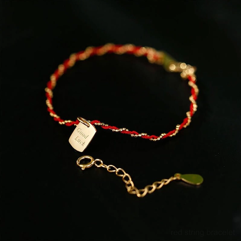 Red string bracelet with adjustable sterling silver extension chain and green tipped cord end
