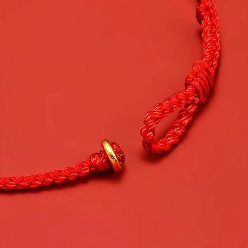 Red string luck bracelet worn on female wrist casual daily shot