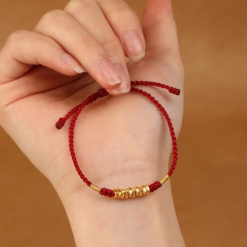 Gold beaded red string protection bracelet hand-held detail