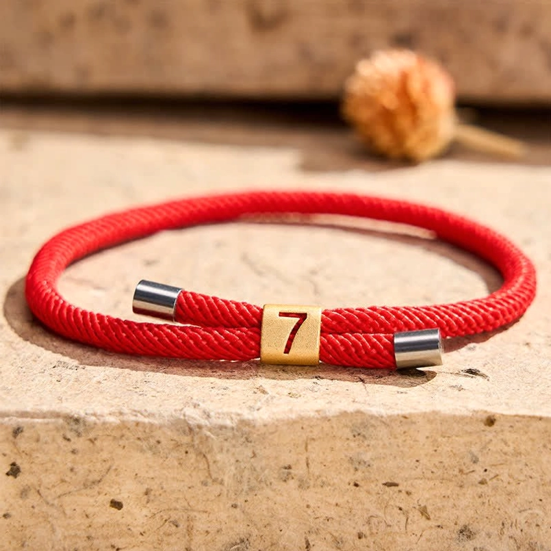 Red string protection bracelet handmade craftsmanship close-up