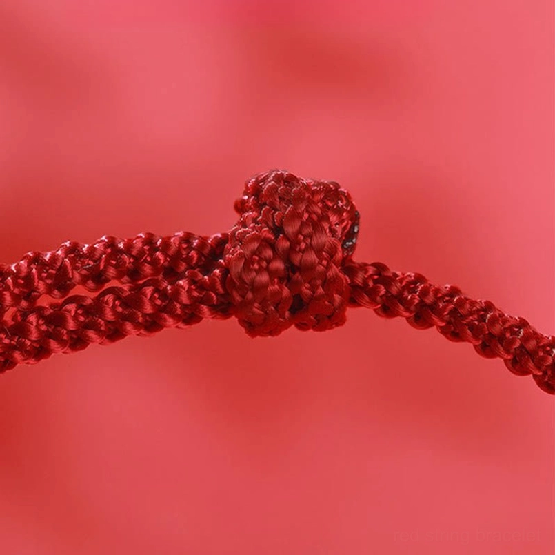 Red string bracelet handmade craftsmanship woven bead detail