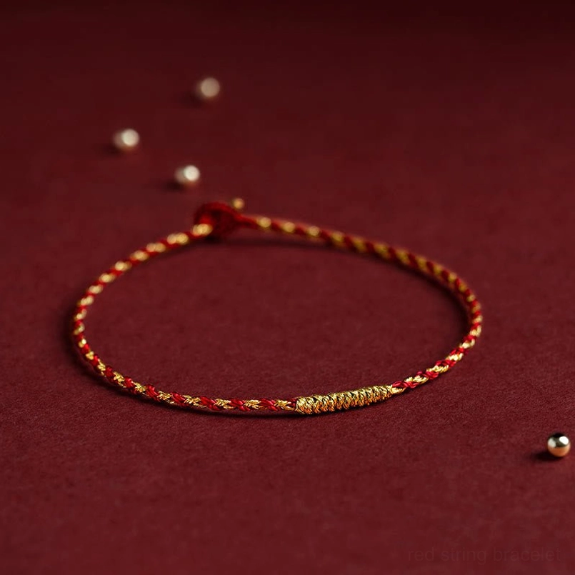 Red string bracelet with adjustable slip knot and King Kong knot detail, burgundy background