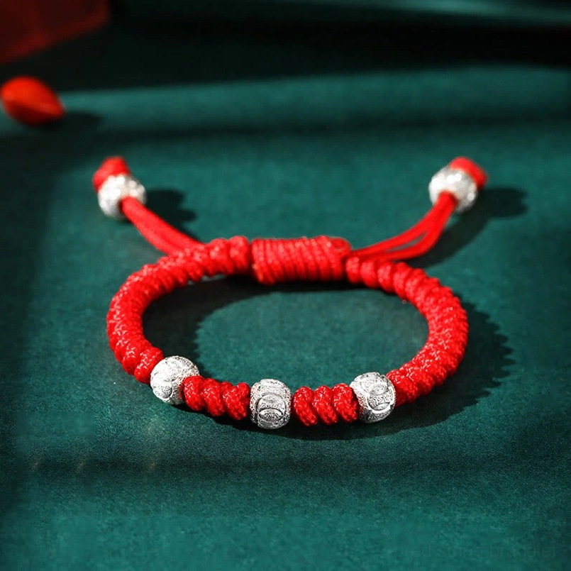 Red string King Kong knot bracelet with twisted red rope, multiple sterling silver beads, and tassel adjustable ends