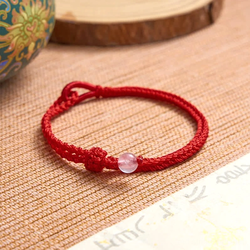 Red string balance bracelet adjustable knot closure and cord weave detail