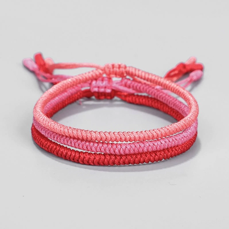 King Kong knot protection bracelet frontal flat lay deep red woven design adjustable ends