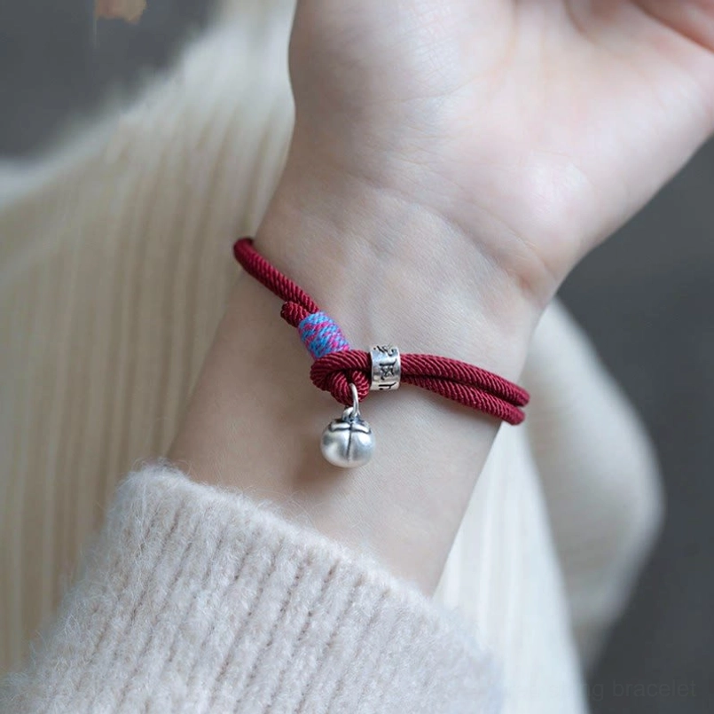 Tibetan protection bracelet wine red worn on female wrist with sweater