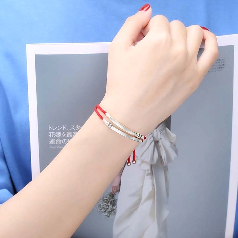 Red string silver bar bracelet worn on wrist showing dual layered sterling silver accents and comfortable fit