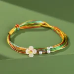 Multicolor red string bracelet with white peach blossom flower charm and pearl beads, adjustable woven cord
