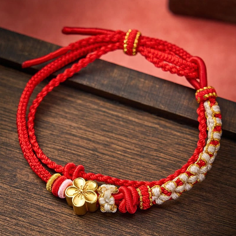 Handwoven red double layer bracelet with peach blossom pendant flat lay top view