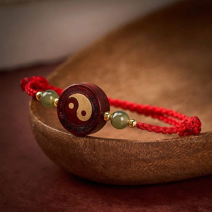 Yin-yang protection bracelet jewelry photography with wooden bowl