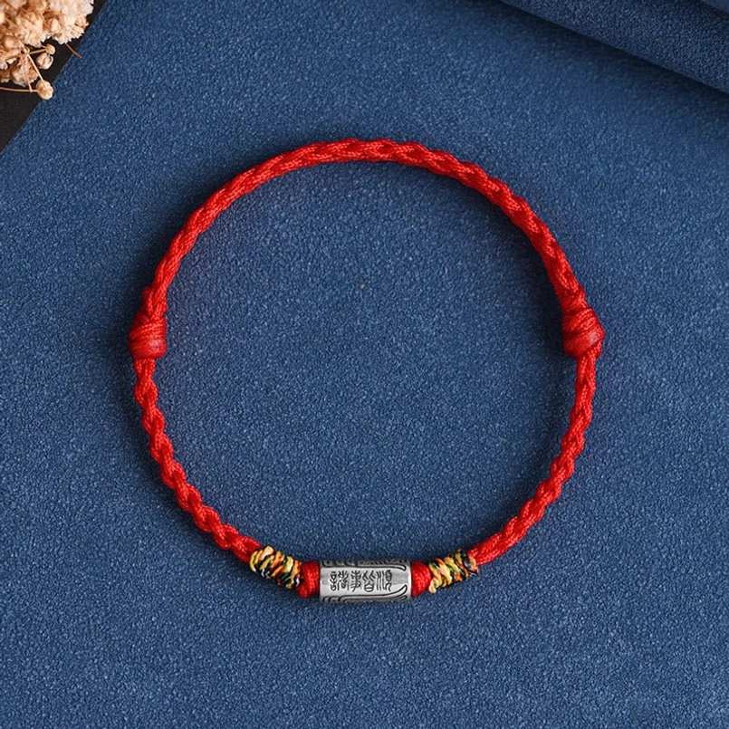 Single red woven lucky bracelet with engraved sterling silver charm and dried flowers