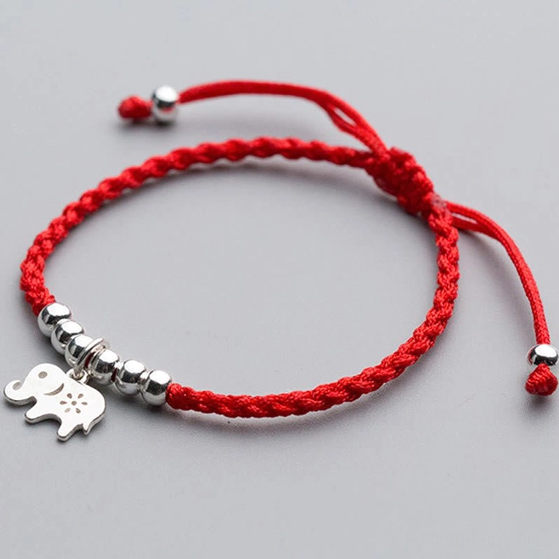 Red string luck bracelet with silver elephant pendant and clustered silver beads