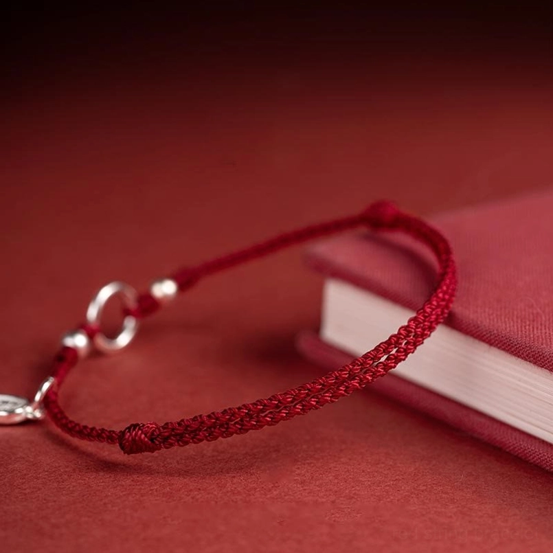 braided red cord sterling silver clasp beads on hardcover book display
