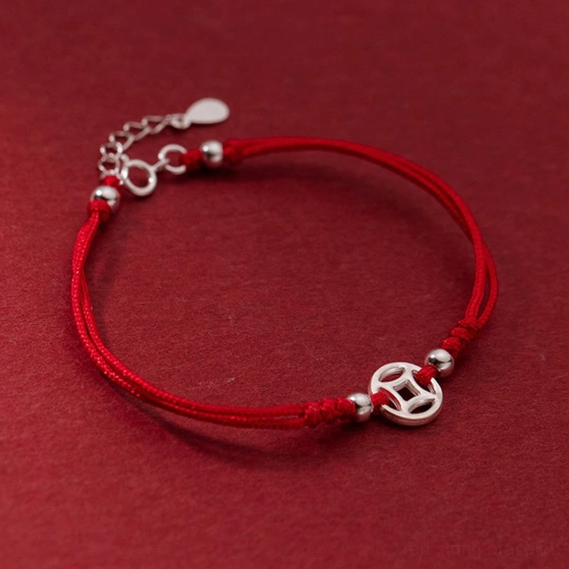 red string lucky bracelet three-quarter angle view with silver coin charm and adjustable chain
