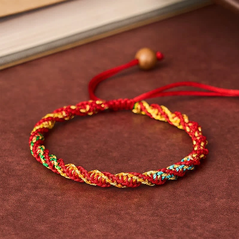 Multicolor braided red string bracelet with adjustable wooden bead, side angle detail shot