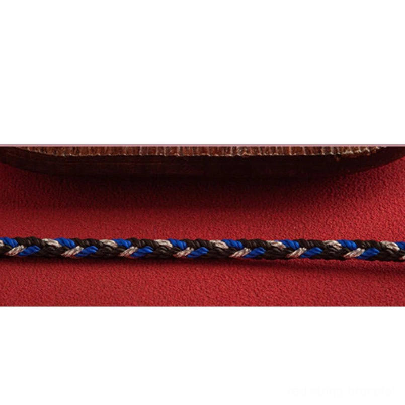 Multicolored red string bracelet close-up showing tri-color weave texture and knot detail