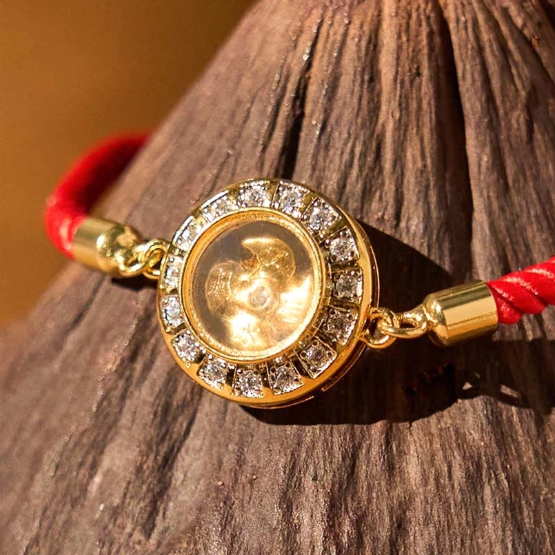 Close-up of rotating windmill charm with cubic zirconia halo and gold center