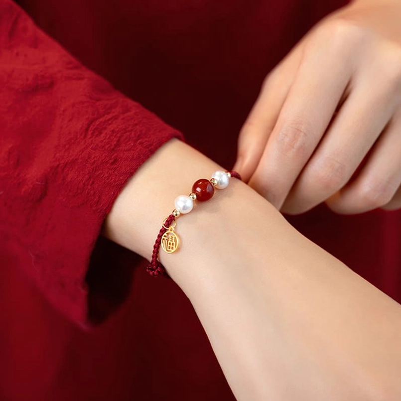 Adjustable red string bracelet with gold Fu charm fitting on wrist comfort and size demonstration