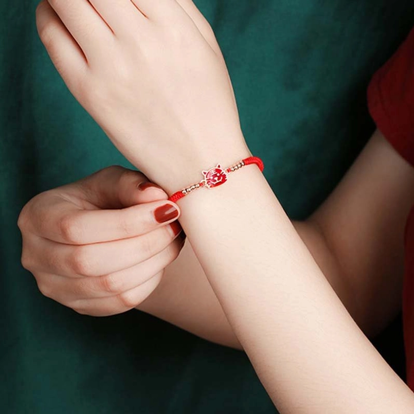 Chinese red string bracelet worn on wrist enamel charm rose gold hardware