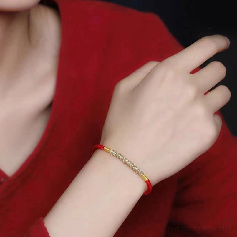 Handmade red string silver bracelet worn on wrist showing slim dual-tone design fit