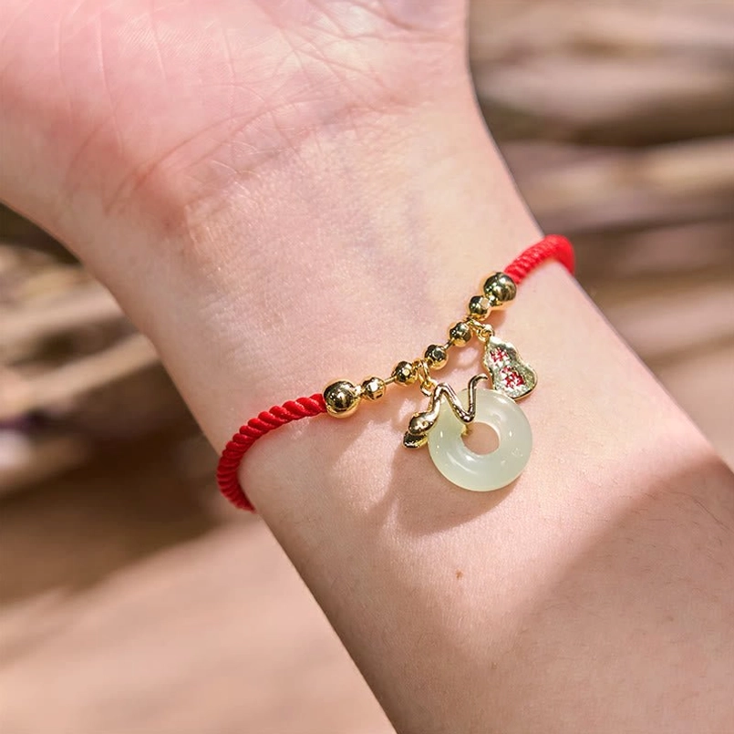 Red string lucky bracelet worn on wrist showing delicate jade peace buckle fit