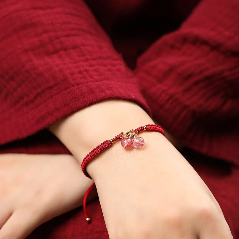 Wearing Red String Strawberry Quartz Bracelet on Wrist - Lifestyle Photo