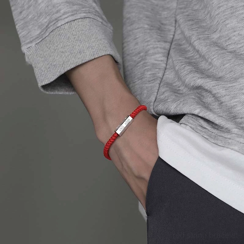 Red string 925 silver engraved charm bracelet worn on wrist casual daily look