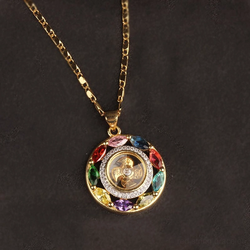 Sacred red string bracelet with matching rotating zircon copper pendant flat display