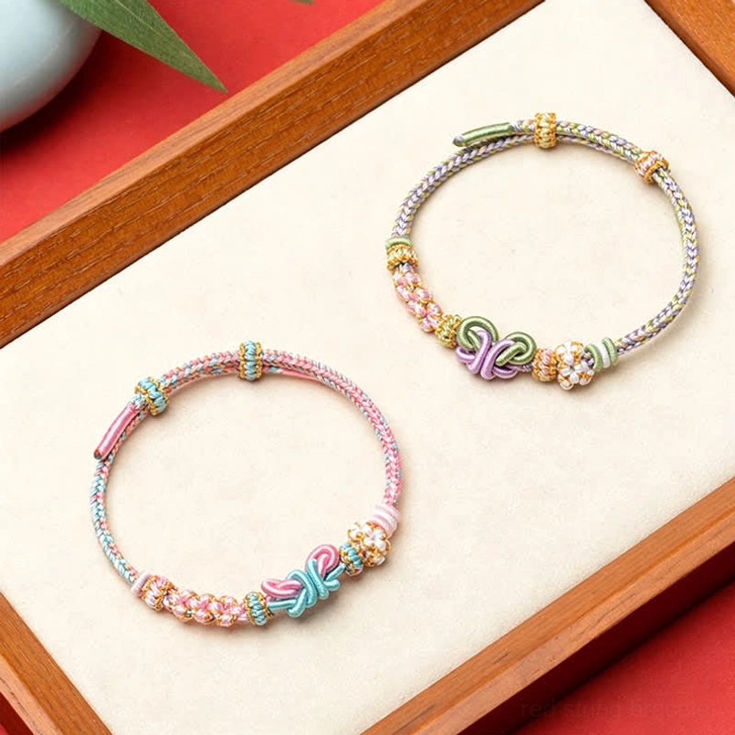 Red string butterfly adjustable bracelet with protective energy and beaded decoration front view