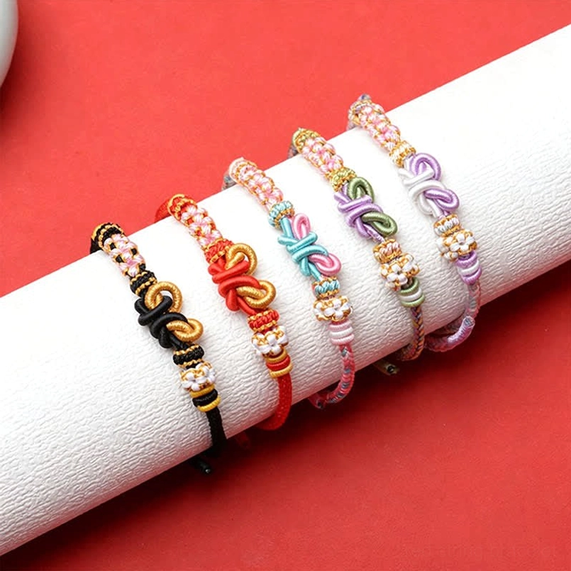 Red string butterfly luck bracelet handcrafted with natural materials and beaded accent