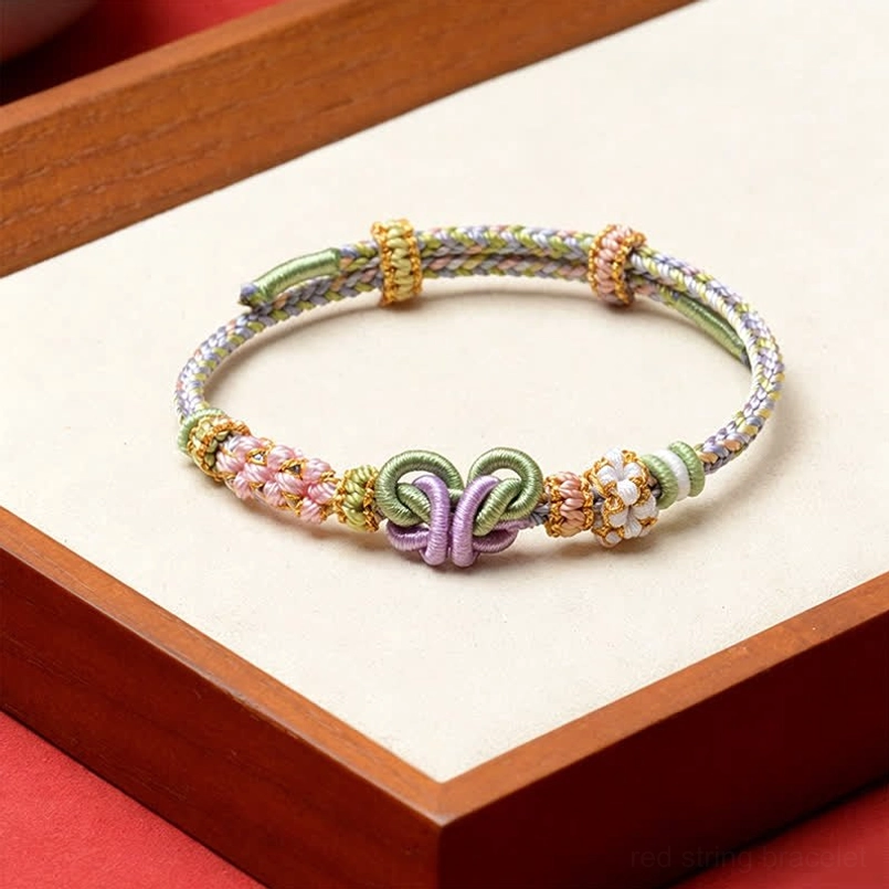 Multicolor pastel woven red string butterfly bracelet with purple double knot and flower accents
