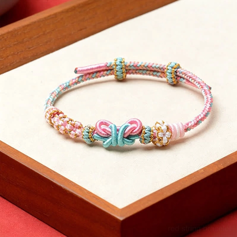 Pastel pink and blue handmade red string butterfly bracelet with butterfly knot and bead details