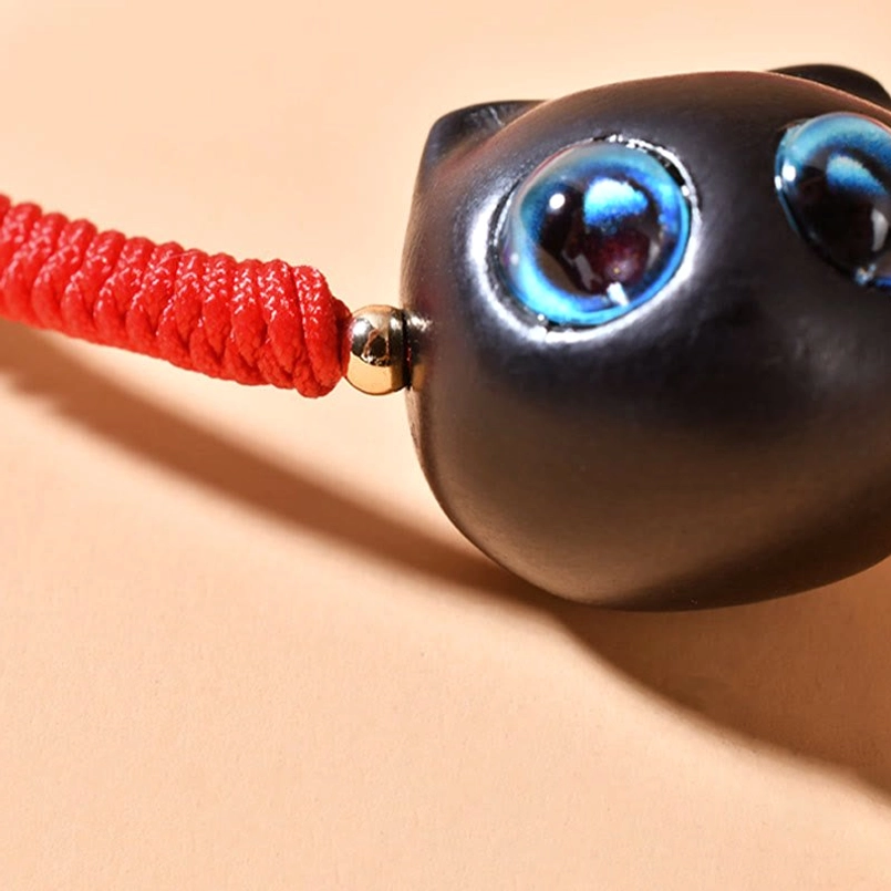Red string cat bracelet showing traditional sliding knot adjustable design