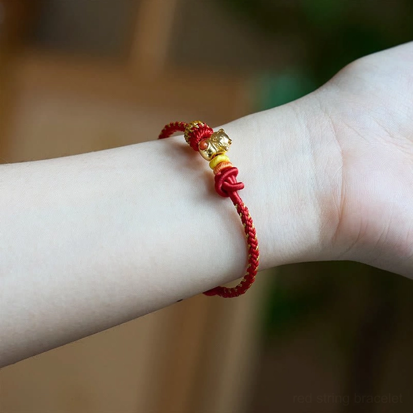 Copper cat charm red string luck bracelet worn on human wrist daily wear view