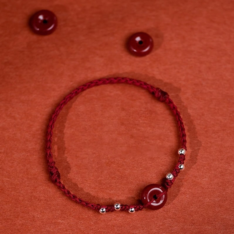 Red string cinnabar bracelet woven cord design with protective blessing energy