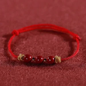 Red braided cinnabar bracelet front flat view with 3 cinnabar beads
