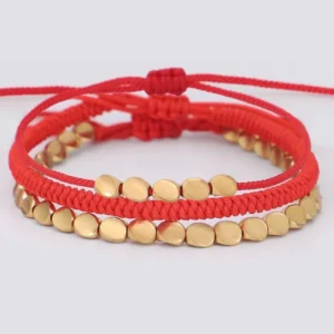 3 piece red string copper bead bracelets with adjustable knots on white background