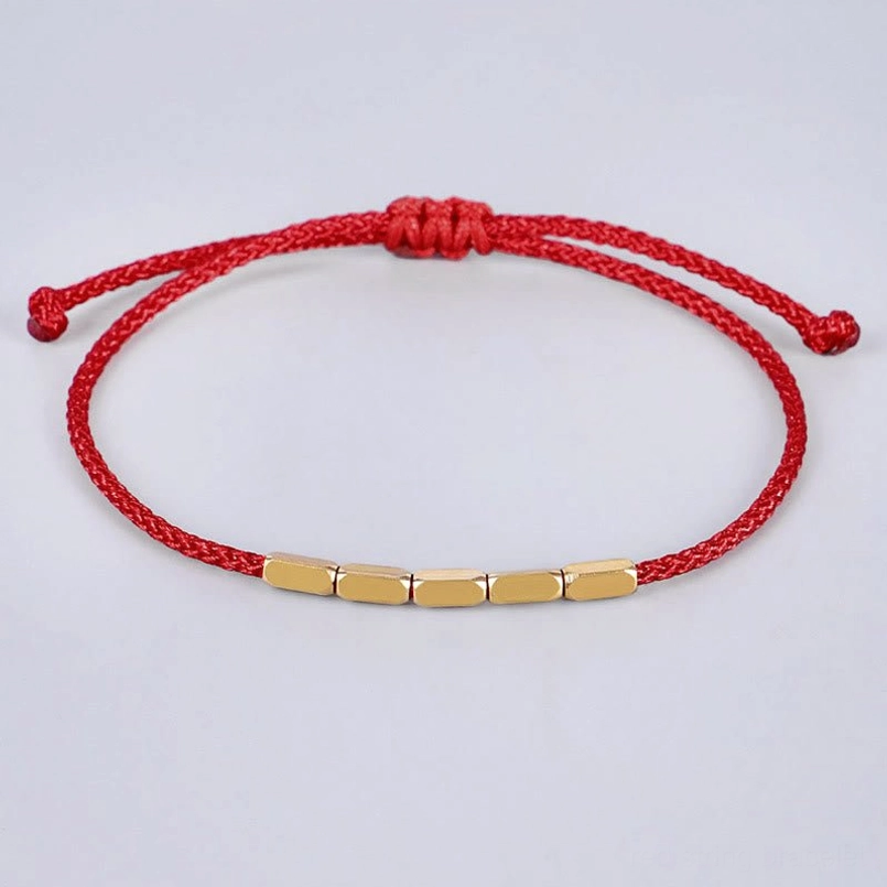 Handcrafted red string bracelet with rectangular copper beads and adjustable knot