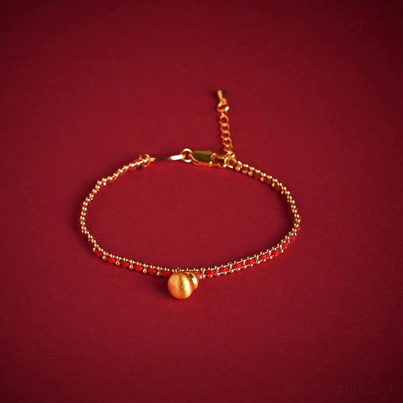 Red string copper brass gourd bracelet with adjustable tail chain and gold beads on dark background