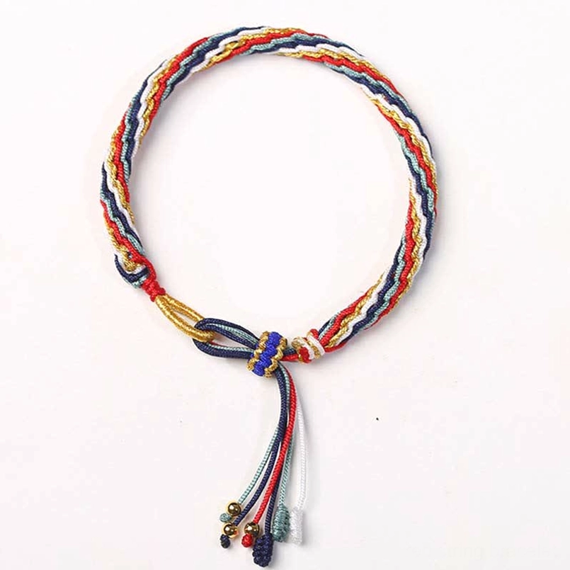 Handcrafted red string bracelet with red gold and blue braided knot and metal bead tassel design