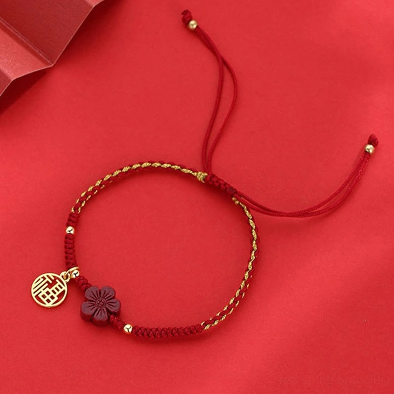 Cinnabar Fu bracelet with red-gold twisted strands and adjustable drawstring