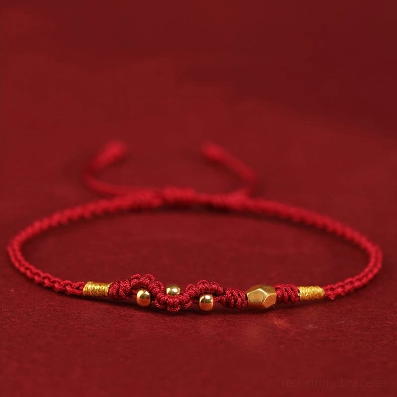 Red string 999 gold bead bracelet top view with adjustable sliding knot