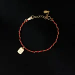 925 sterling silver red string good luck bracelet front view with engraved charm on black background