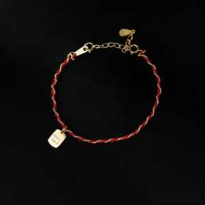 925 sterling silver red string good luck bracelet front view with engraved charm on black background