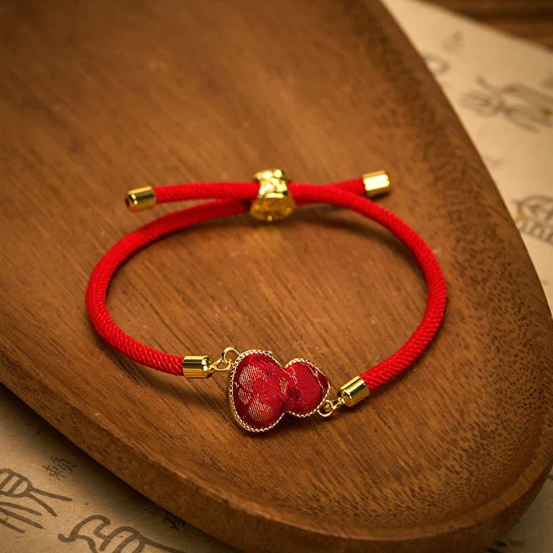 Adjustable red string gourd bracelet featuring gold metal buckles and red brocade gourd pendant