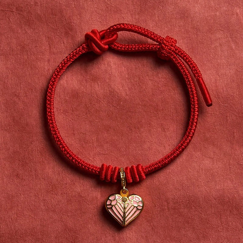 Artisan handmade red string bracelet featuring delicate heart charm and flexible sizing